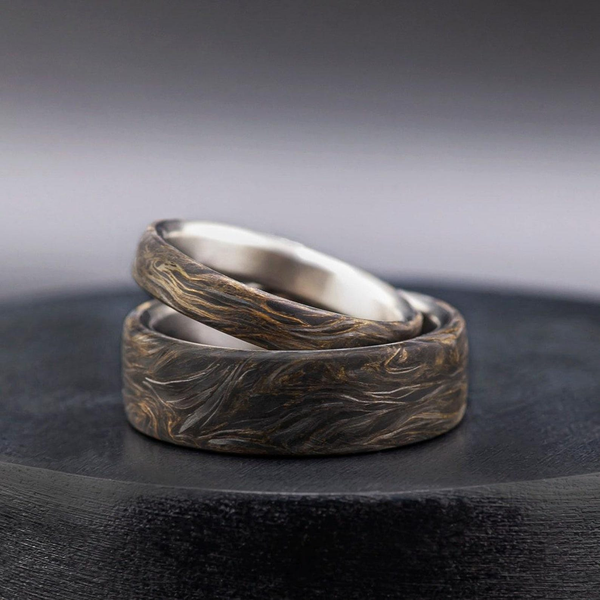 Elegante anillo de titanio con láminas de oro y fibra de carbono