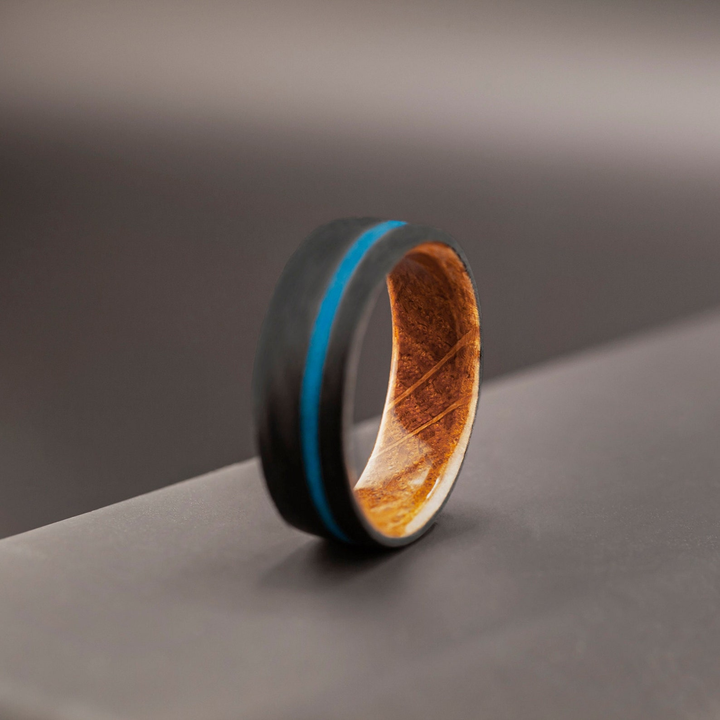 Durable men’s ring with carbon fiber core and natural inlays
