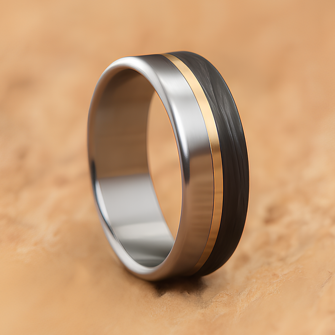 Men's titanium band split between brushed metal and dark carbon fiber, divided by a brass line