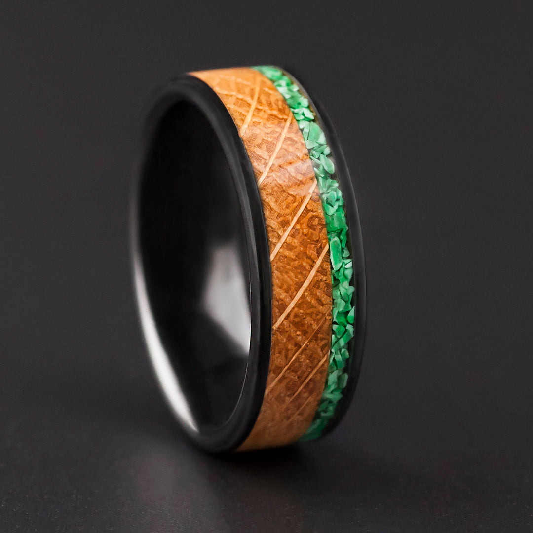The Cask black ceramic wedding band with whiskey barrel oak and green malachite inlay