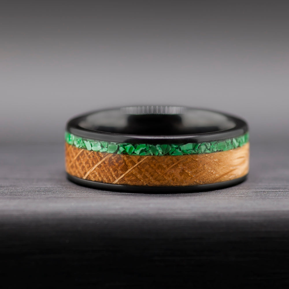 Mens bourbon ring in black ceramic with reclaimed whiskey oak and malachite inlay