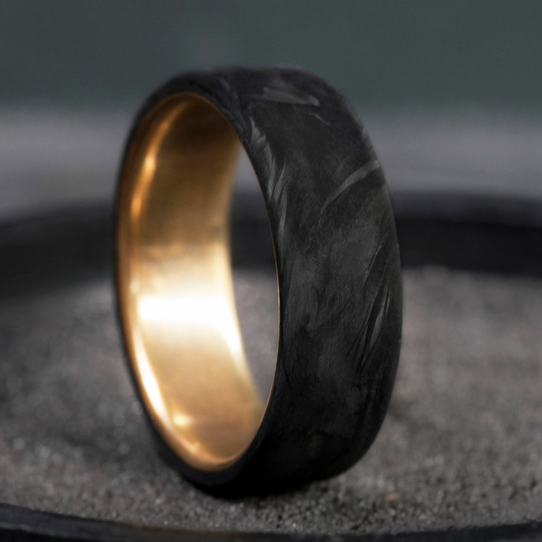Forged carbon fiber mens wedding band with brass core, matte black domed finish