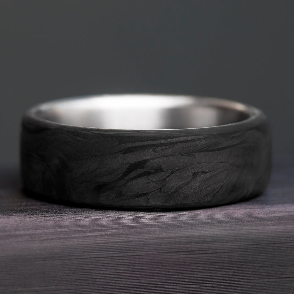 Forged carbon fiber surface detail - marbled dark pattern without grid - titanium wedding band