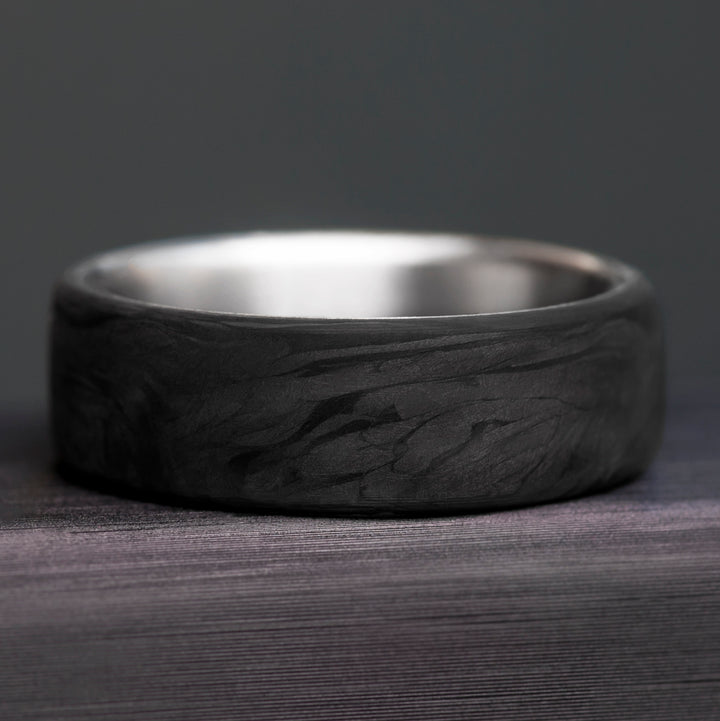 Forged carbon fiber surface detail - marbled dark pattern without grid - titanium wedding band