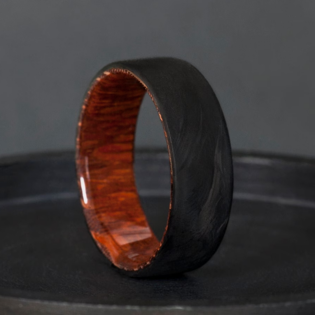 Rare snakewood with a forged carbon fiber ring made for daily wear.