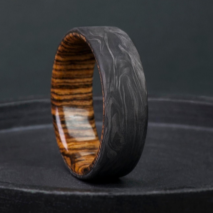 Forged carbon fiber ring built around a bocote wood interior