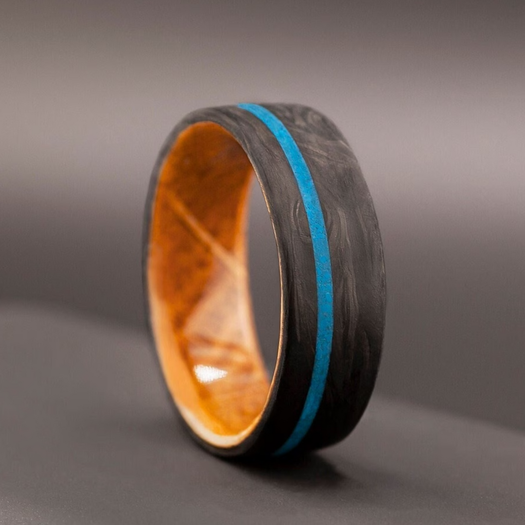 Handmade carbon fiber ring with a crushed turquoise inlay