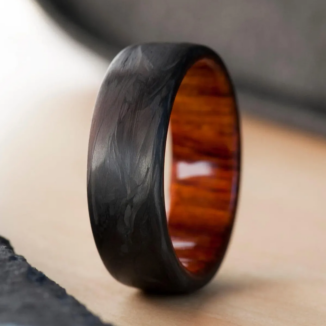 Handmade engagement ring that combines forged carbon fiber with a cocobolo wood interior. 
